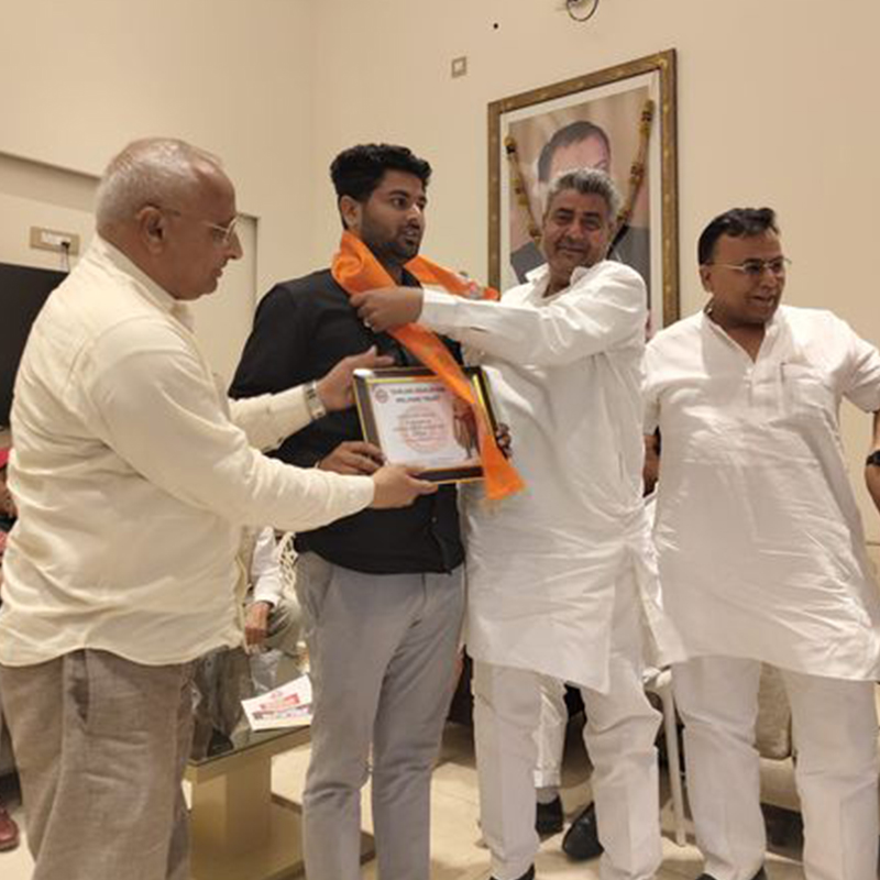 Photo of a field full of flowers, a blue sky and a tree.